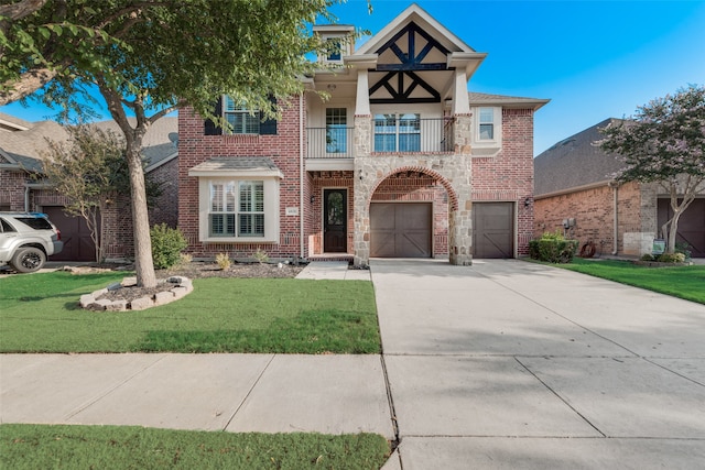 view of front of home with a balcony, a garage, and a front lawn