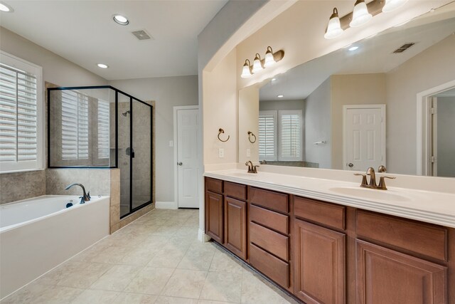 bathroom featuring vanity, independent shower and bath, and tile patterned floors