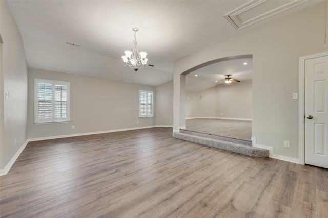 unfurnished living room featuring ceiling fan with notable chandelier, lofted ceiling, and light hardwood / wood-style floors