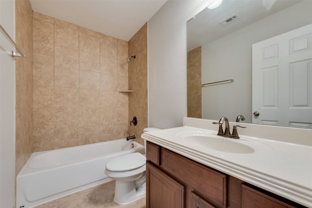 full bathroom featuring tile patterned flooring, tiled shower / bath, toilet, and vanity