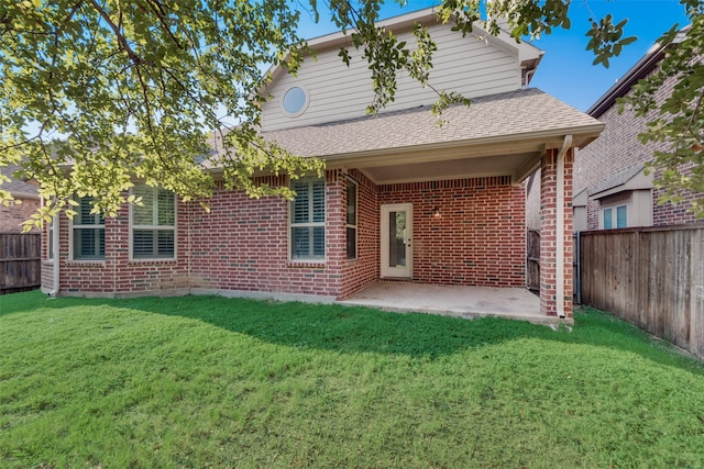 back of property featuring a yard and a patio area