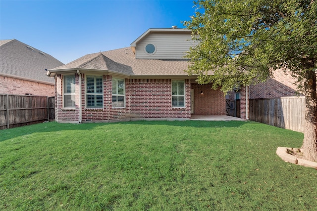 back of property with a patio area and a yard