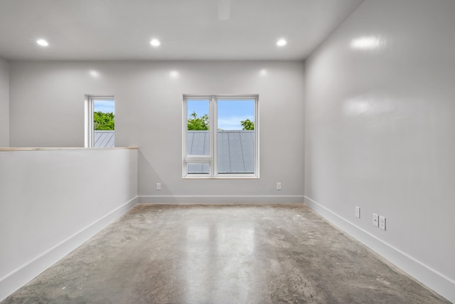 empty room with concrete flooring