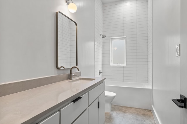 full bathroom featuring toilet, tiled shower / bath combo, and vanity