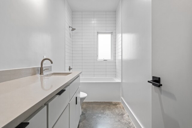 full bathroom with tiled shower / bath combo, vanity, toilet, and concrete floors