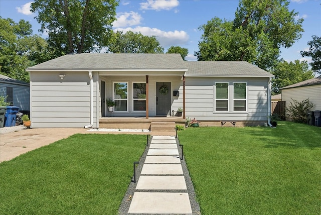 single story home with a front yard and covered porch