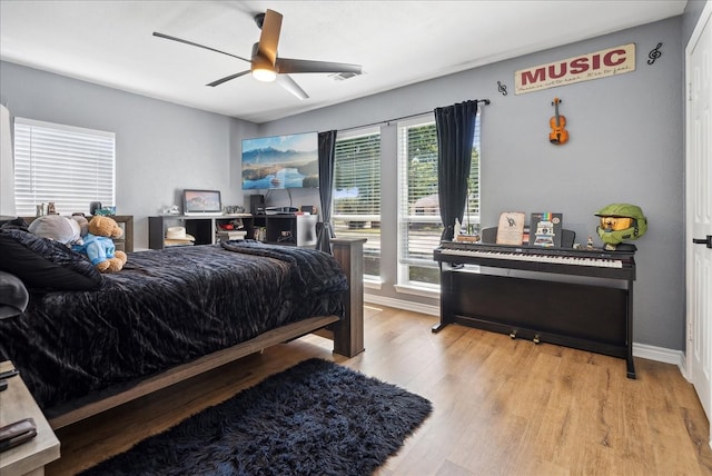 bedroom with ceiling fan and light hardwood / wood-style flooring