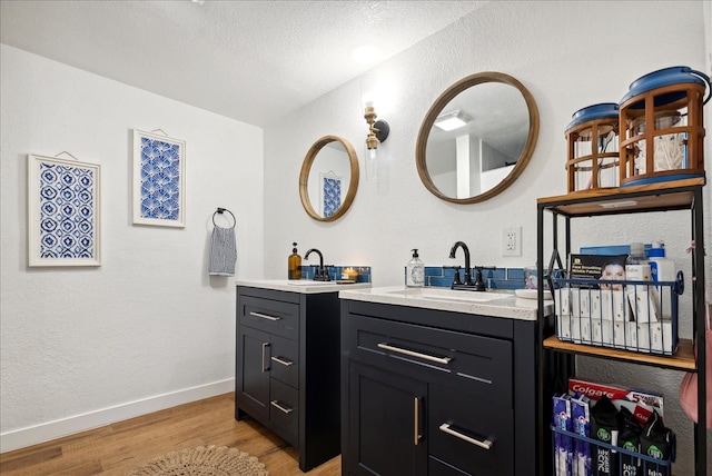 bathroom featuring a textured ceiling, vanity, and hardwood / wood-style flooring