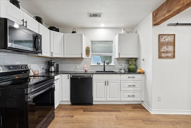 kitchen with black appliances, beam ceiling, light hardwood / wood-style floors, sink, and white cabinetry