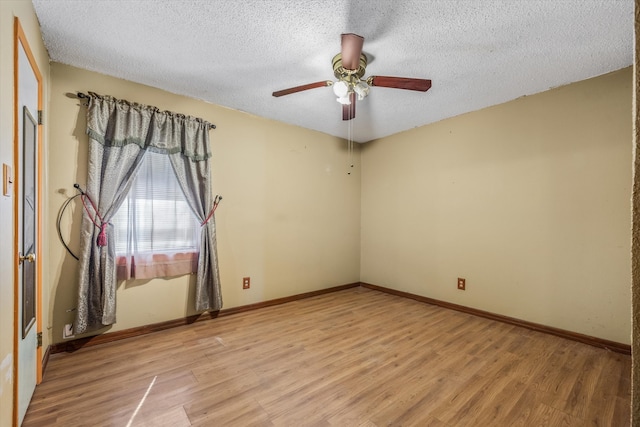 empty room with a textured ceiling, light hardwood / wood-style flooring, and ceiling fan