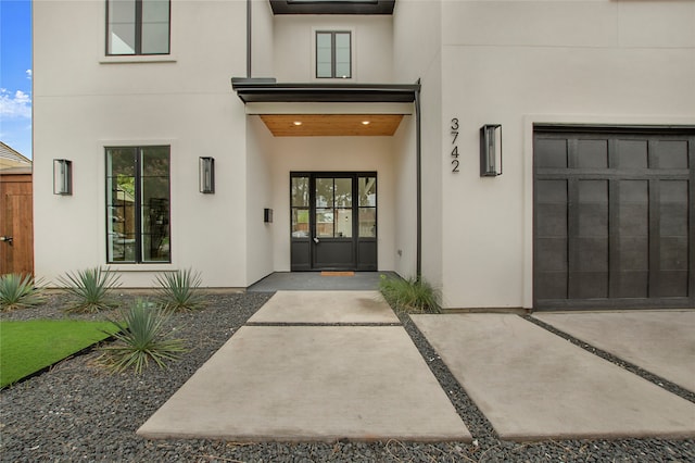 doorway to property with a garage