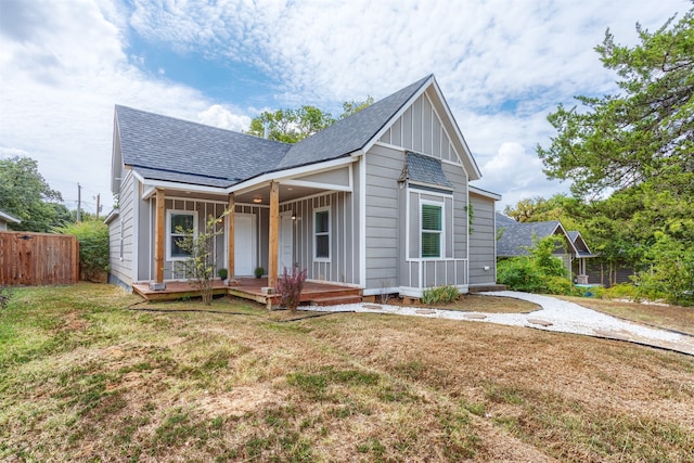 view of front facade with a front yard and a porch