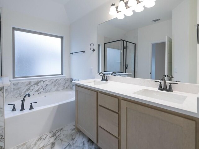 bathroom featuring vanity, independent shower and bath, and vaulted ceiling