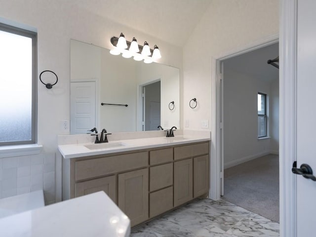 bathroom with vanity and lofted ceiling