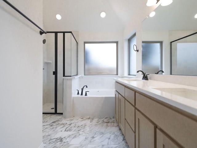 bathroom featuring shower with separate bathtub and vanity