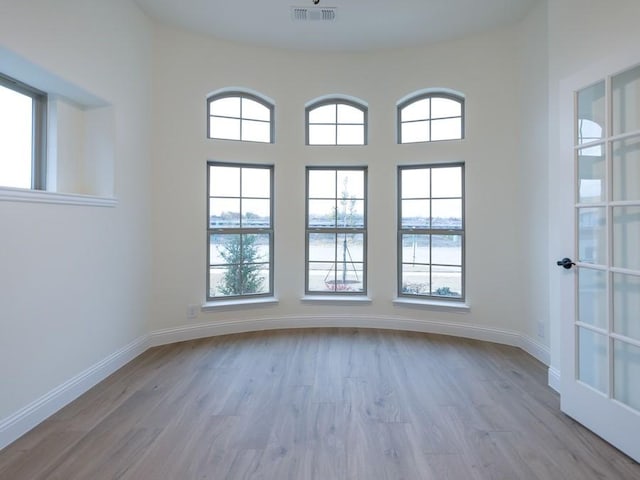 unfurnished room with light hardwood / wood-style flooring