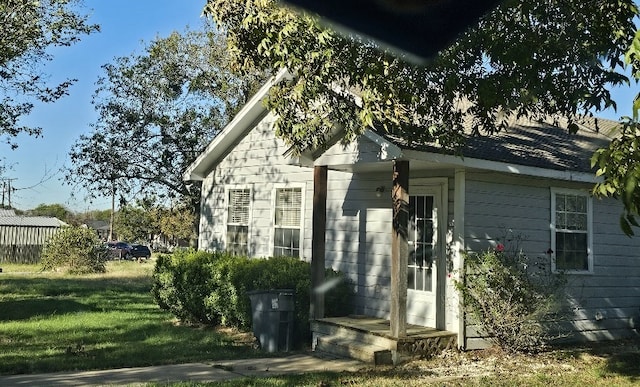 view of side of home with a lawn