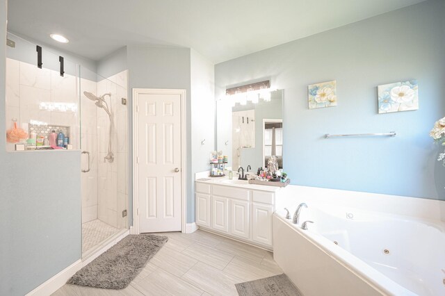 bathroom with independent shower and bath and vanity