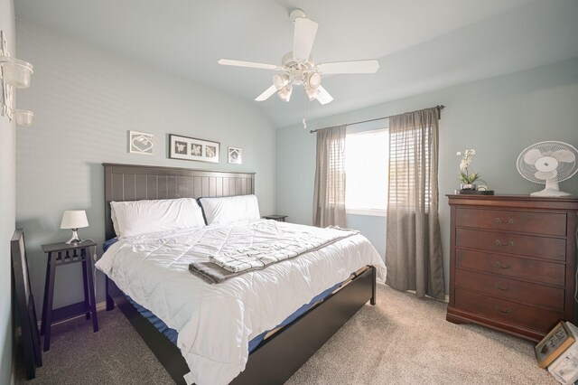 carpeted bedroom featuring lofted ceiling and ceiling fan