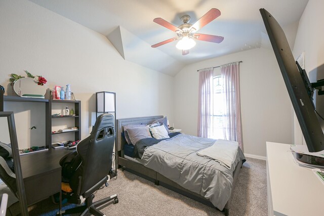 carpeted bedroom with ceiling fan and vaulted ceiling