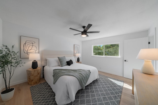 bedroom with ceiling fan and light hardwood / wood-style flooring