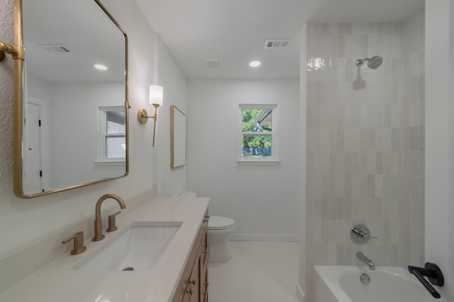 full bathroom featuring toilet, tiled shower / bath combo, and vanity