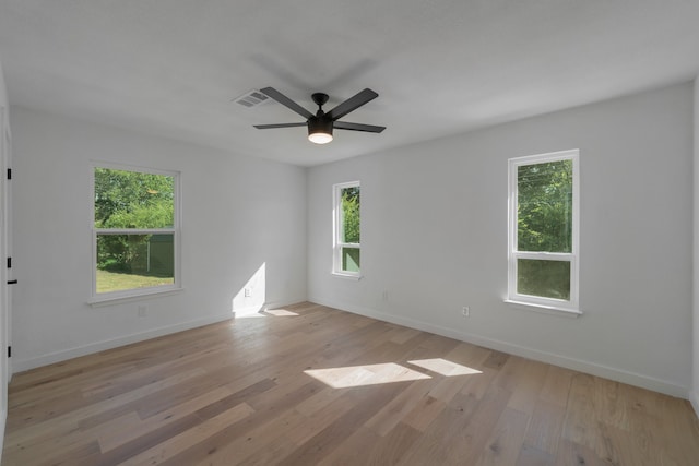 empty room with ceiling fan and light wood-type flooring