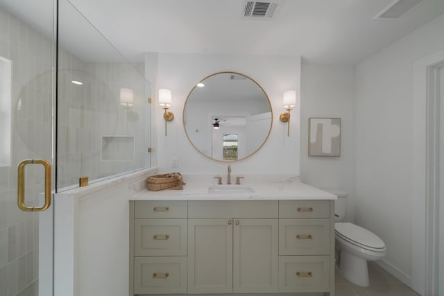 bathroom with vanity, toilet, tile patterned floors, and a shower with door