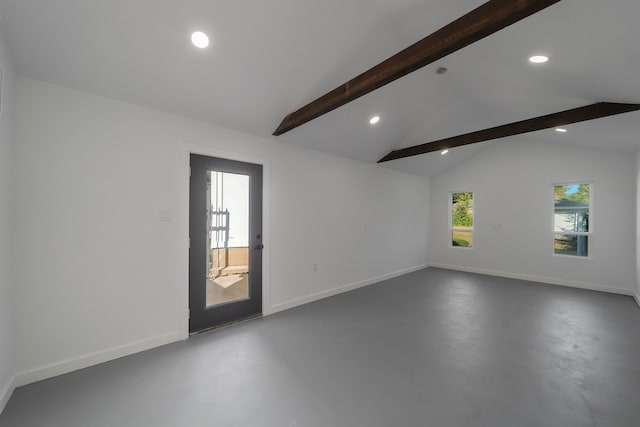 empty room featuring lofted ceiling with beams