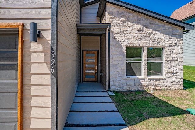 doorway to property featuring a lawn