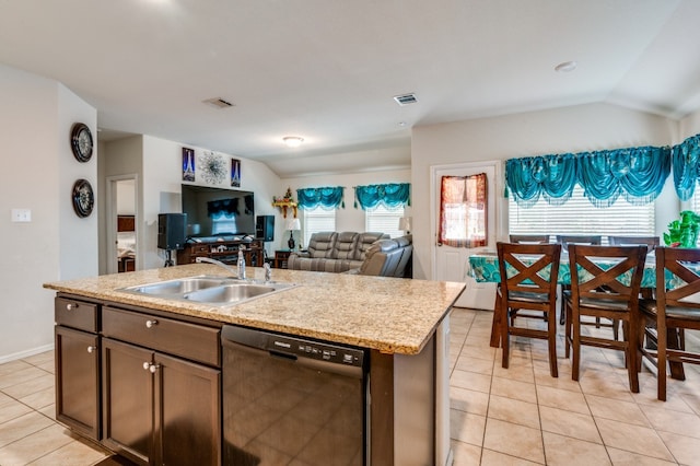 kitchen featuring lofted ceiling, a center island with sink, sink, black dishwasher, and dark brown cabinets