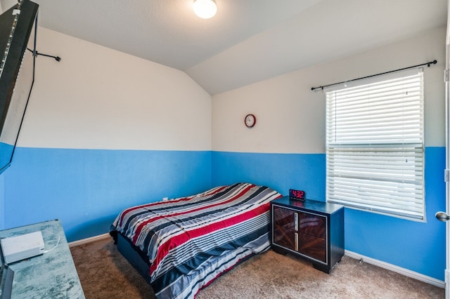 carpeted bedroom with vaulted ceiling