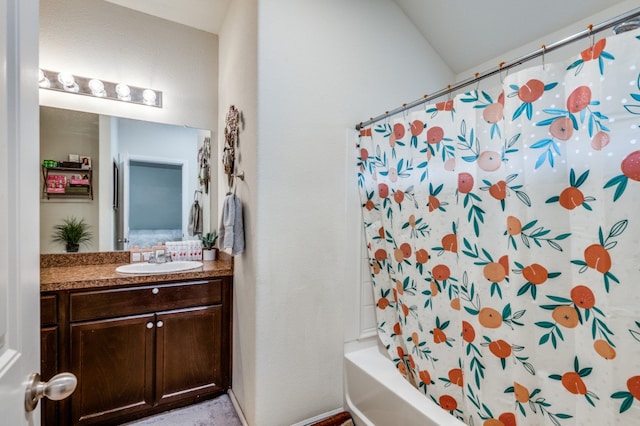 bathroom featuring vanity, shower / bath combo with shower curtain, and lofted ceiling