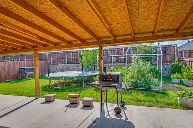 view of patio / terrace with a trampoline and a grill