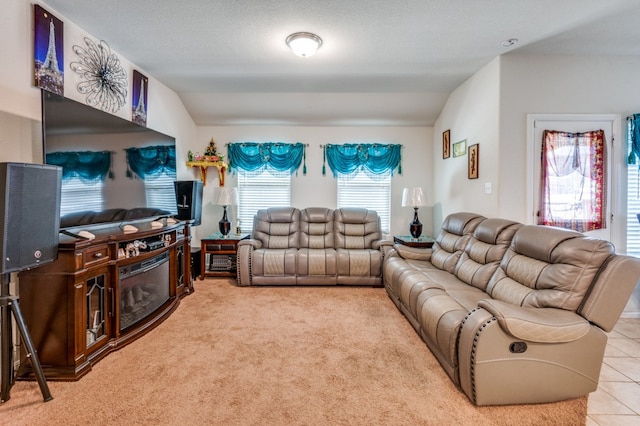 living room with light carpet, a textured ceiling, and vaulted ceiling