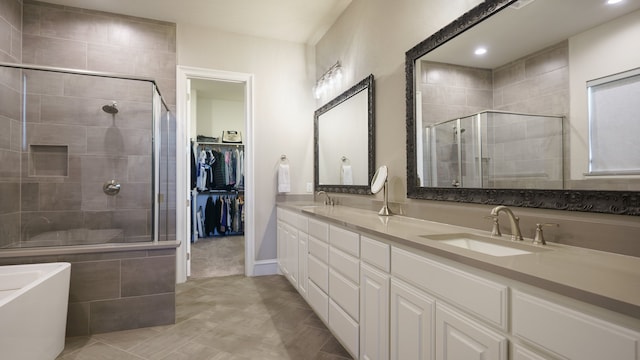 bathroom featuring separate shower and tub and vanity