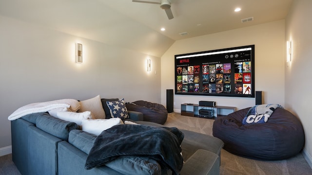 home theater with lofted ceiling, ceiling fan, and carpet flooring