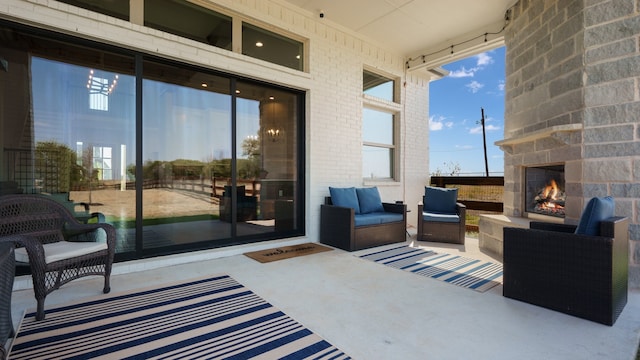 view of patio / terrace featuring an outdoor living space with a fireplace