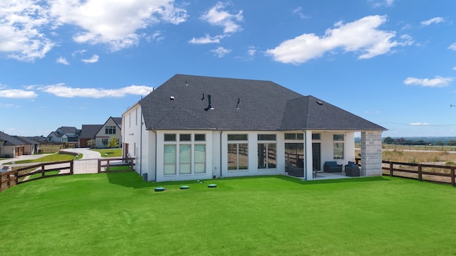 rear view of house with a lawn