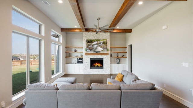 living room with plenty of natural light, ceiling fan, hardwood / wood-style floors, and a stone fireplace