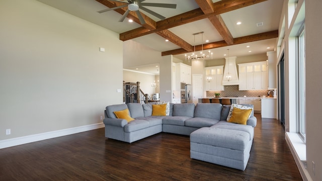 living room featuring ceiling fan with notable chandelier, dark hardwood / wood-style flooring, plenty of natural light, and beam ceiling