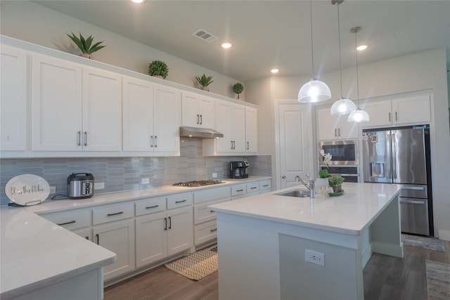 kitchen featuring appliances with stainless steel finishes, pendant lighting, dark hardwood / wood-style flooring, and white cabinetry