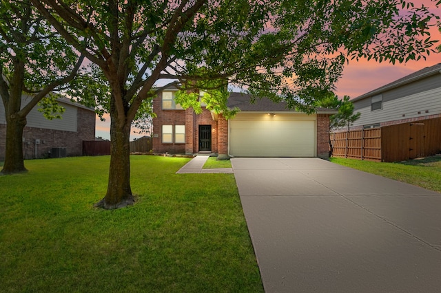 view of front facade featuring central AC unit, a garage, and a yard