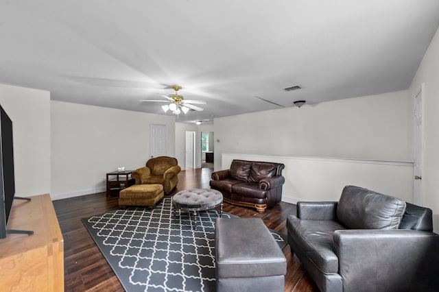 living room with ceiling fan and dark wood-type flooring