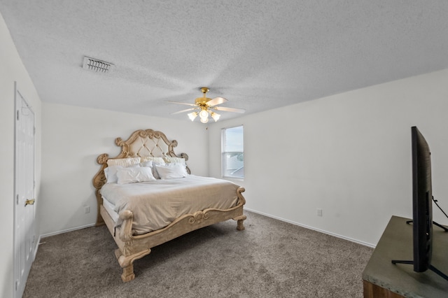 carpeted bedroom with ceiling fan and a textured ceiling