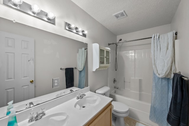 full bathroom featuring shower / bathtub combination with curtain, tile patterned floors, a textured ceiling, toilet, and vanity