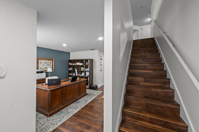 stairs featuring hardwood / wood-style floors