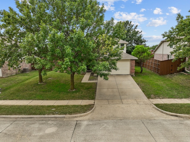 view of front of property featuring a front yard and central AC