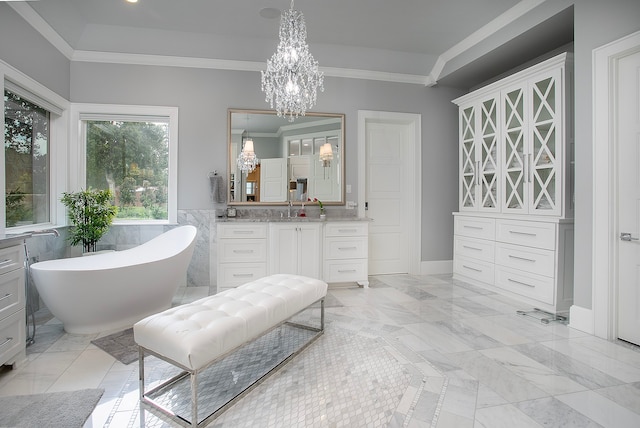 bathroom featuring a bath, ornamental molding, vanity, and an inviting chandelier