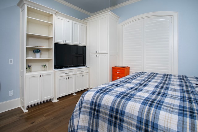 bedroom featuring a closet, dark wood-type flooring, and crown molding